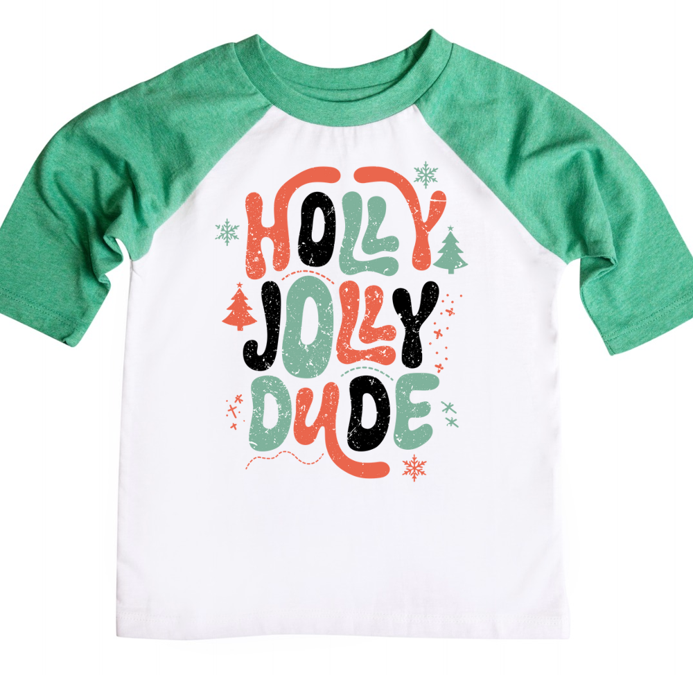 Green and white raglan shirt featuring the fun holiday phrase 'Holly Jolly Dude' in bold orange, green, and black letters, surrounded by festive elements like snowflakes, Christmas trees, and stars.